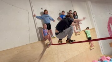 Ninja Runs Up Wall And Lands On Gymnastics Bar