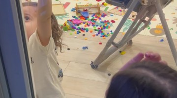 Child Helps His Mother Open the Door