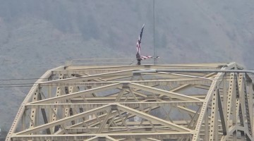 Man Climbs Bridge Illegally and Ties Bicycle to Flag