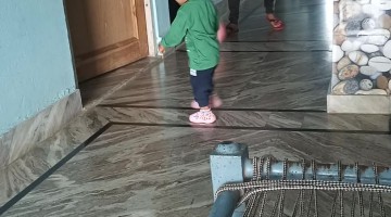 Dad Kicks Soccer Ball at Son