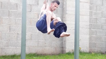 Man Takes Off Clothes While Hanging From Bar