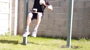 Man Drinks Smoothie While Holding Onto Pull Up Bar