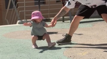 Dad Keeping His Little Girl Steady After a Dizzying Spin at the Park