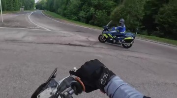 Motorcycle Driver Cuts Across Roundabout Just as Police Pull Up