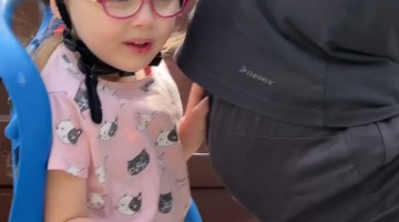 Girl on Bike Biting Dad