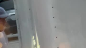 Wind Blows Loose Trailer in Parked Car