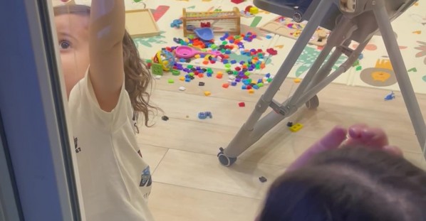 Child Helps His Mother Open the Door