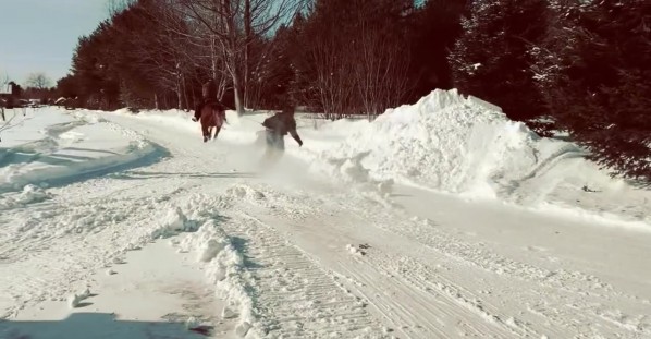 Snowboarder Pulled By Horse Practices for Skijoring Competition