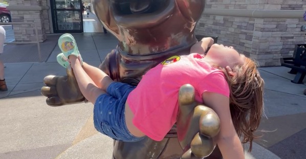 Beaver Mascot Statue Cradles Young Fan
