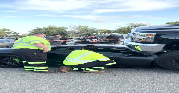 Aftermath of Lifted Truck Driving Over Luxury Sportscar