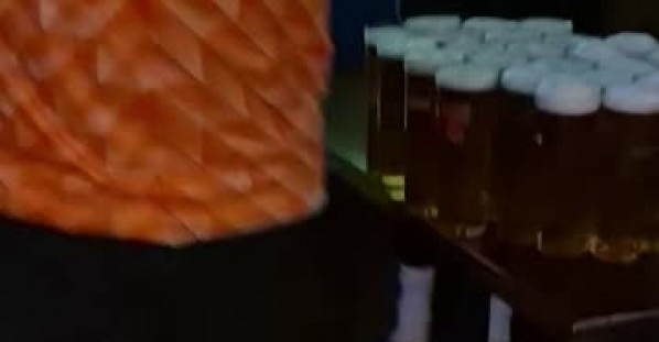 Dutch Fan Carries Arm-Load of Beer to Table