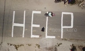 Indonesians chalk large "HELP" on ground as authorities fear more than 5,000 still missing