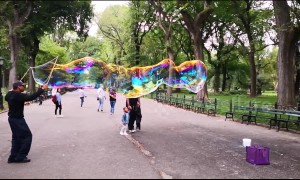 Slow motion footage of bubble man in Central Park, NY