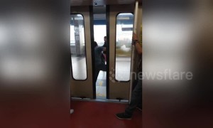 Furious passengers kick their way out of jammed train door