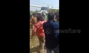 Indian farmers carry Air Force plane on shoulders after crash