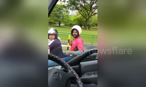 Pillion passenger wears helmet the wrong way round