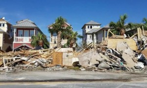 Piles of debris from flattened houses lie on side of Mexico Beach roads