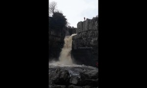 Adrenaline junkie flings self down waterfall during UK floods