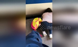 Girl falls between platform and train at Beijing station while mom glued to phone