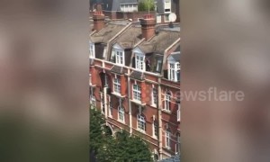 UK window cleaner seen on ledge three floors up with no safety equipment