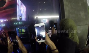 Excited London fans watch rapper Jaden Smith perform through shop window