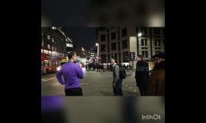 Eccentric man with megaphone shouts at jay-walkers in London