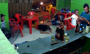 Oblivious Man Plays with Phone During Armed Robbery