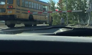 School Bus Crosses Closed Train Tracks