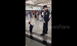 Cute boy just wants a hug from airport security guard