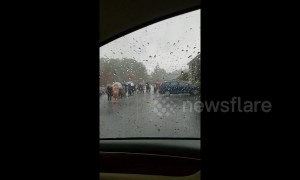 People queue in thunderstorms to vote in Georgia