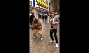 Sax player in NYC subway plays Bruno Mars tune as homeless man dances