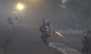 Indian villagers hurl homemade firecrackers at each other in mock war after Diwali