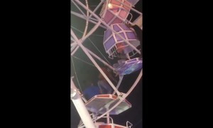 Ferris wheel gondolas flip upside down with families inside