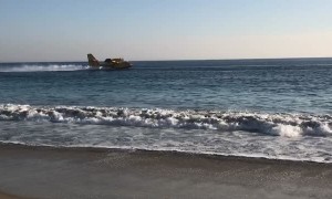 Aircraft Retrieves Ocean Water for Fire Fighting Efforts