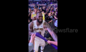 Young fan freaks out when LeBron hands his arm sleeve to him