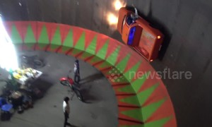 Pick-up truck takes on motorcycle wall of death at Thai fair