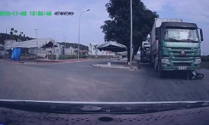 Man Crashes Motorcycle and Narrowly Escapes Moving Truck