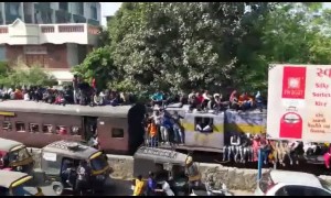 Indian pilgrims surf train in huge numbers en route to holy festival