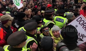 Scuffles break out as police force their way into London climate protest