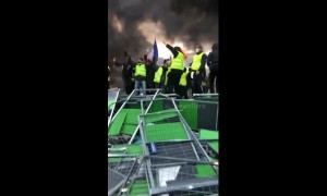 Fuel tax protesters light fire on Champs-Elysées in Paris