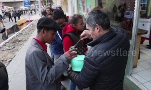 Footage shows local Tijuana shop owner serving food to Honduran migrants