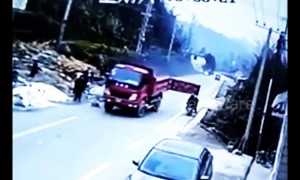 Family on scooter taken out by back door on lorry trailer