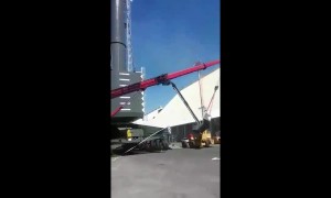 Men left hanging metres in the air after crane falls in freak accident