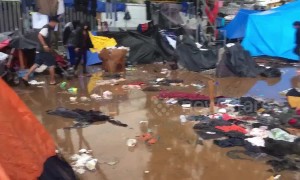 Tijuana migrant shelter a muddy mess as rain pours down