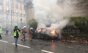Firefighters extinguish blazing car during Paris "yellow vests" protest