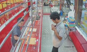 Bungling thief tries to flee gold shop only to be foiled by locked door