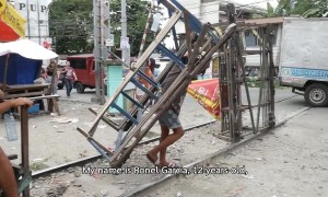 Manila 'trolley boys' use handmade carts to ferry commuters on illegal railway