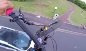 Daredevil cyclist uses car to boost speed in spectacular jumps
