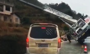 Two men narrowly escape being buried by crane falling over on road