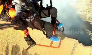 Woman makes daring flight across volcanic crater using motorcycle-powered paraglider